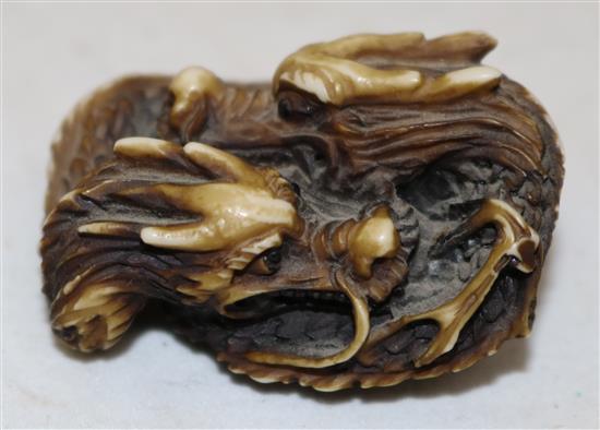 A Japanese stag antler netsuke of two entwined dragons, 20th century, 4.5cm